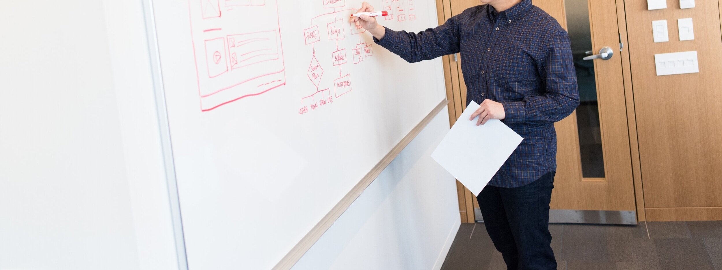 person-holding-marker-pen-near-door-1181310